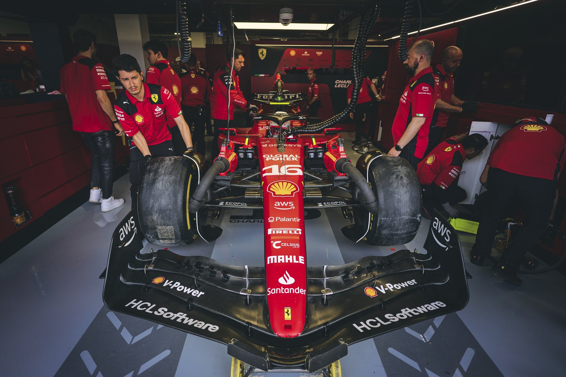 Scuderia Ferrari car in the garage with mechanics